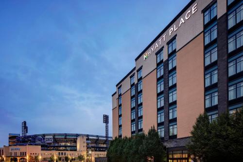 a building with a baseball stadium in the background at Hyatt Place Pittsburgh North Shore in Pittsburgh