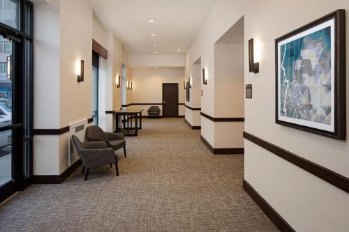 a hallway of a hotel with chairs and a table at Hyatt Place Pittsburgh North Shore in Pittsburgh