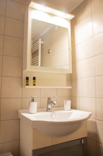 a bathroom with a sink and a mirror at Nanos Studios in Parga