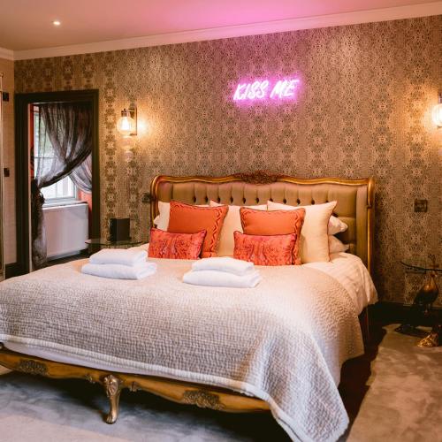 a bedroom with a large bed with two pillows on it at The Tempus at Charlton Hall Estate in Alnwick