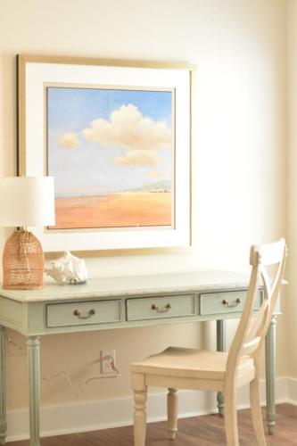 a desk with a painting on the wall at New! HEATED POOL, BEACH HOUSE, Elevator, Walk to the Beach! in Hilton Head Island