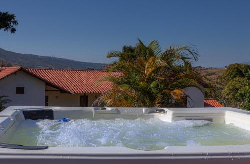 a bath tub filled with water in front of a house at Casa de Teja Barichara in Barichara