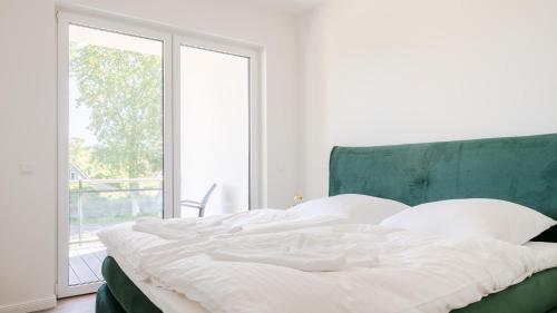 Postel nebo postele na pokoji v ubytování Apartmenthaus Wittsande Wittsande 10