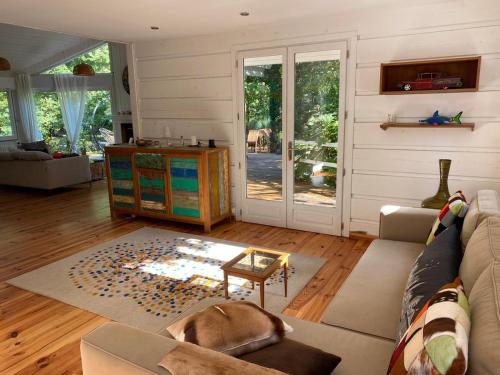 a living room with a dog laying on a couch at L'Esprit d'O in Lacanau
