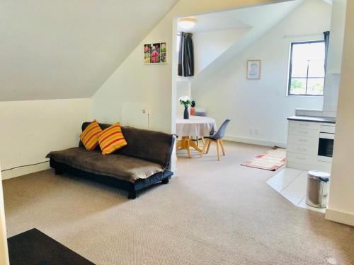 a living room with a couch and a table at Spacious, Peaceful, Fully Equipped 1BR Apartment in Upper Hutt