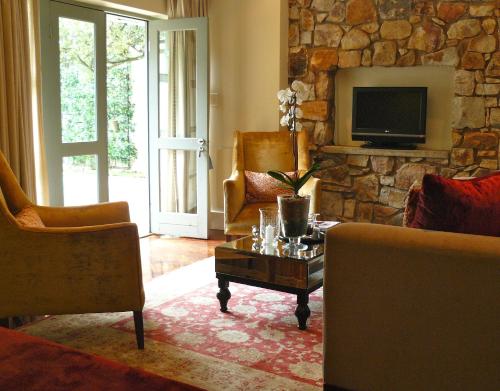a living room with a couch and a tv at The Parkwood in Johannesburg