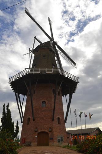 a large brick windmill with a sky in the background at Apto Top Centrum Holambra/excelente localização in Holambra