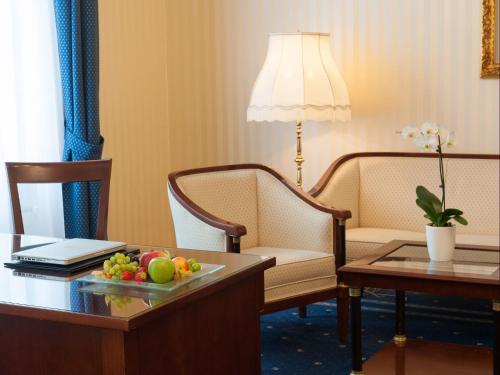 a hotel room with a table with a plate of fruit at Hotel Ambassador in Vienna