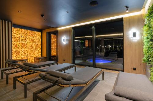 a living room with two chairs and a couch at Artis Loft Hotel in Radziejowice