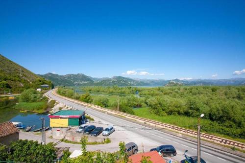 a parking lot with cars parked next to a road at Skadar Lake Apartment-Nikola in Podgorica