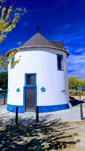 a small white church with a cross on the top at Route 2 Torrão in Torrão