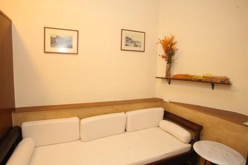 a living room with a white couch in a room at En Ermoupoli in Ermoupoli
