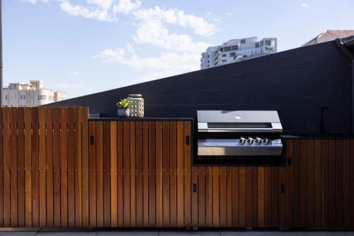 a fence with a stove on top of it at Regents Court Sydney in Sydney