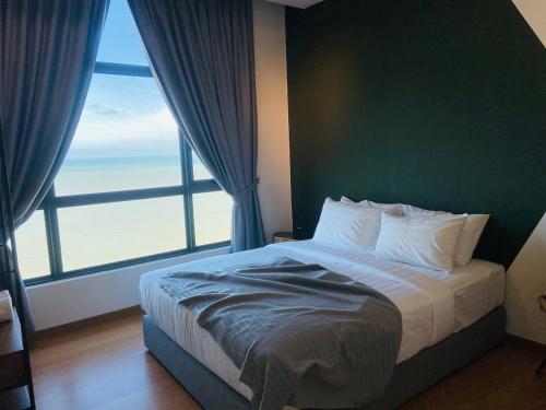 a bedroom with a bed with a large window at Kuantan Imperium by Glex in Kuantan