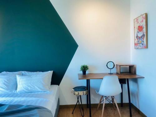 a bedroom with a bed and a table and a chair at Kuantan Imperium by Glex in Kuantan