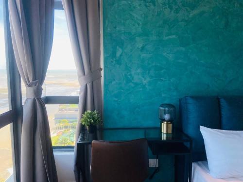 a bedroom with a window with a bed and a chair at Kuantan Imperium by Glex in Kuantan