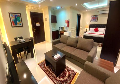 a living room with a couch and a bed at Majestic Hotel in Doha