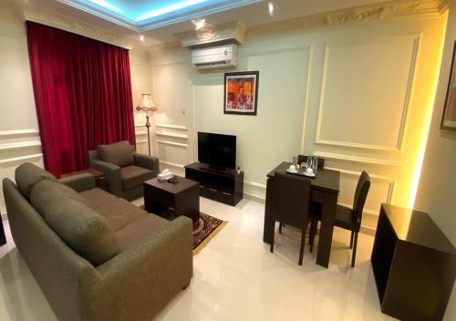 a living room with a couch and a table at Majestic Hotel in Doha