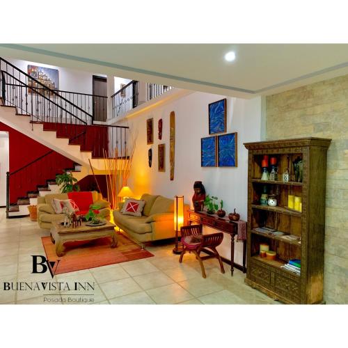 a living room filled with furniture and a staircase at BUENAVISTA INN in Maiquetía