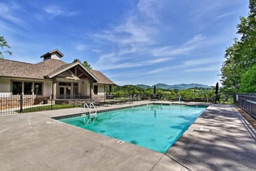a swimming pool in front of a house at Smokies Sanctuary with Mountain Views and Resort Perks in Townsend