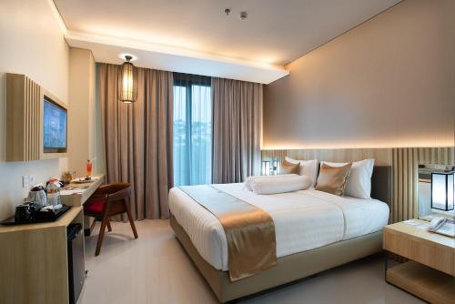 Postel nebo postele na pokoji v ubytování Braling Grand Hotel By Azana Purbalingga