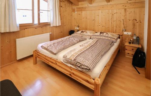een slaapkamer met een bed in een houten kamer bij Nice Home In Bartholomberg With Kitchen in Bartholomäberg