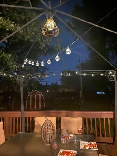 a table with food and drinks on a patio at night at Mi casa su casa in Cheektowaga