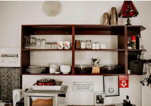 a shelf above a microwave in a kitchen at Knock Out View Clarens in Clarens