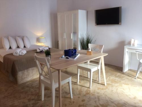a room with a bed and a table and chairs at Psathi Blue Beta in Kimolos