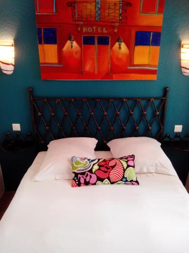 a bed with two pillows on it in a bedroom at Hôtel Brimer Cannes in Cannes