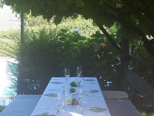 a table with wine glasses on top of it at Weingut Weidlhof - Suite & Breakfast - Vacation for wine lovers in Caldaro