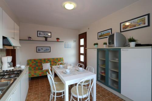 a kitchen with a table and chairs in a room at Villa Stefano in Bibione
