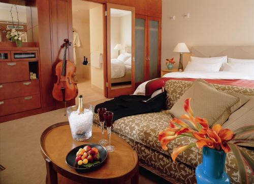 a room with a couch and a table with a violin at Taj Campton Place in San Francisco