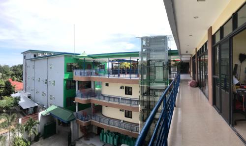 an apartment building with a balcony and a walkway at Southview Hotel in Dumaguete