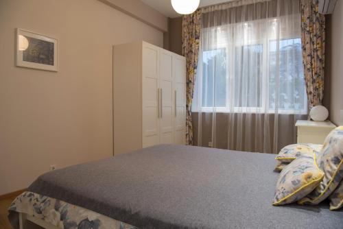a bedroom with a bed and a window at The North Tower Apartment in Sofia