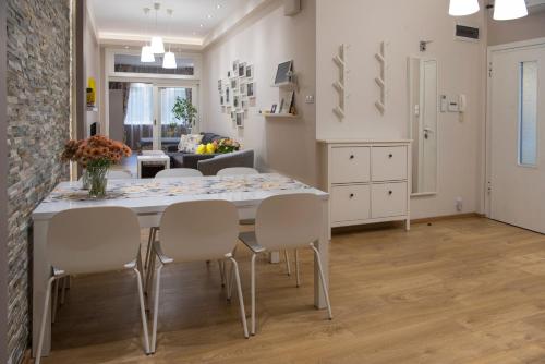 a kitchen and dining room with a table and chairs at The North Tower Apartment in Sofia