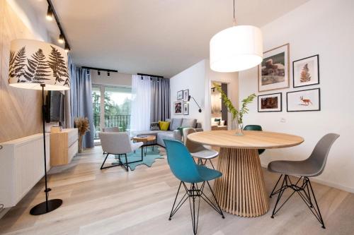 a living room and dining room with a table and chairs at VISLOW Resort in Wisła