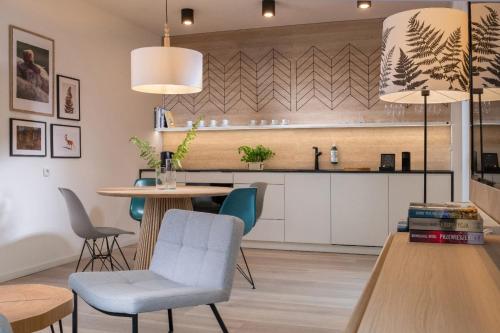 a kitchen and dining room with a table and chairs at VISLOW Resort in Wisła