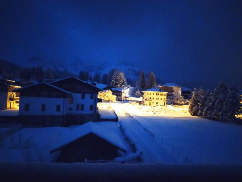 a village in the snow at night at Siora Lina Appartamenti in Vigo di Cadore