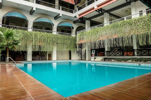 a swimming pool in the courtyard of a building at Airlangga Hotel in Yogyakarta