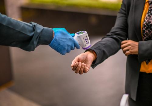 two hands in blue gloves holding a meter at Fortune Park Sishmo, Bhubaneswar - Member ITC Hotels' Group in Bhubaneshwar