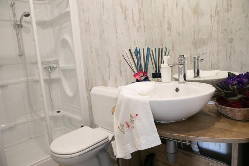 a bathroom with a sink and a toilet and a shower at Ciriga Sicily Glamping in Santa Maria Del Focallo