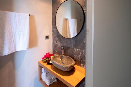a bathroom with a sink and a mirror at 180 South Seaside Hotel in Thermisia