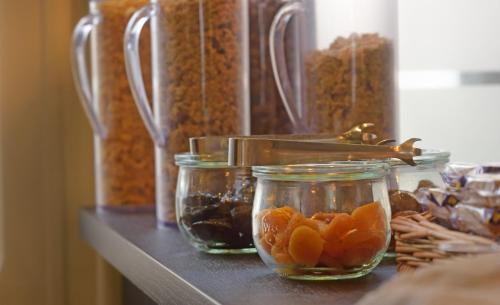 a shelf with glass jars of dried fruits and nuts at Hotel de Champagne in Épernay