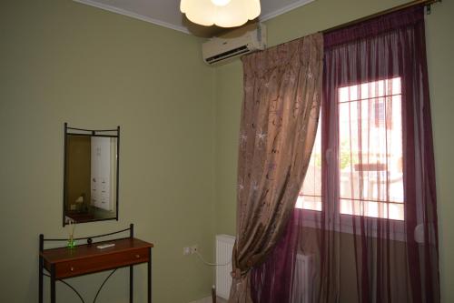 a room with a window and a dresser and a mirror at Marys house in Markopoulo