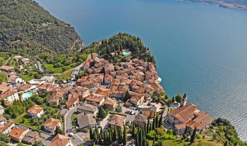 a village on a hill next to the water at Casa La Pief 1 Giallo by Gardadomusmea in Tremosine Sul Garda
