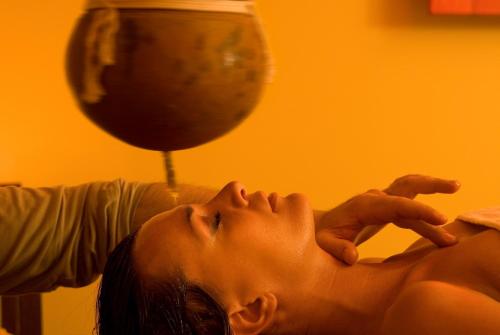 a woman getting a back massage from a therapist at Hotel Metropole in Abano Terme