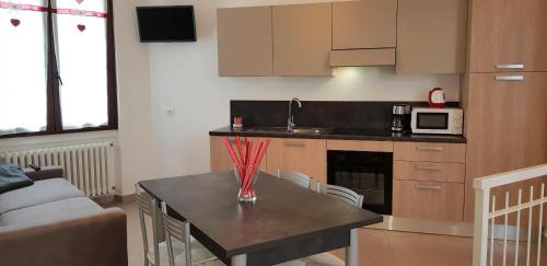 a kitchen with a table with a counter top at Casa La Pief 3 Blue by Gardadomusmea in Tremosine Sul Garda