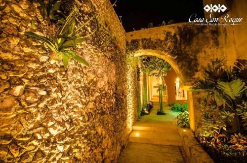 an entrance to a stone wall with an archway at Casa San Roque Valladolid in Valladolid
