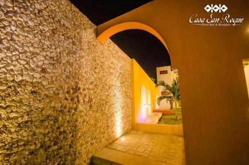 a hallway of a building with a stone wall at Casa San Roque Valladolid in Valladolid
